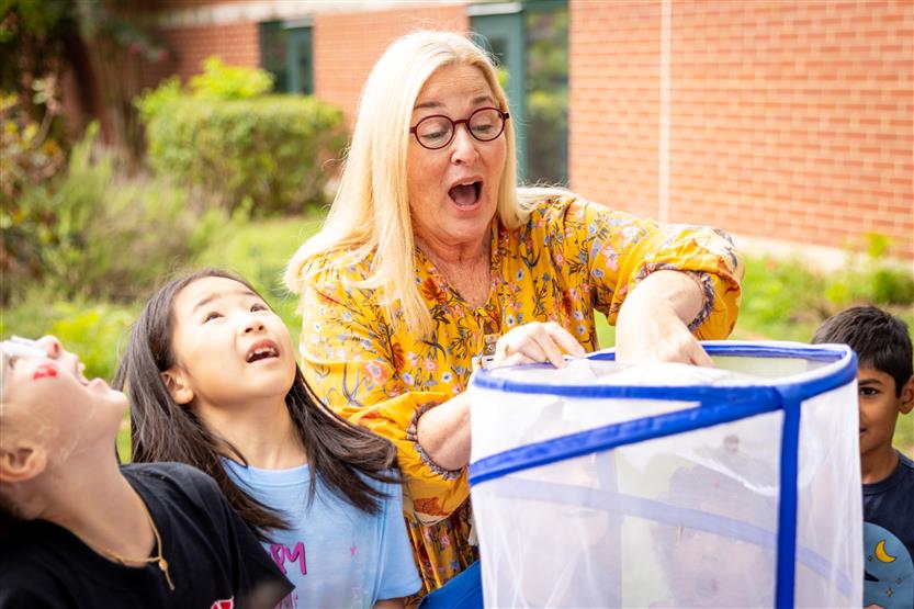 Students watch butterflies being released